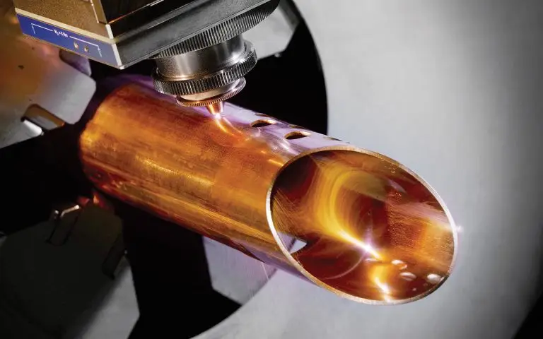 Laser cutting machine precisely cutting holes into a metallic tube with a focused laser beam